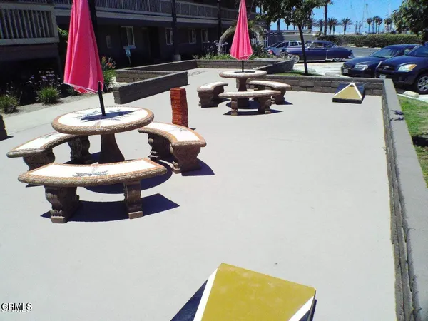 a view of swimming pool with a bench in front of house
