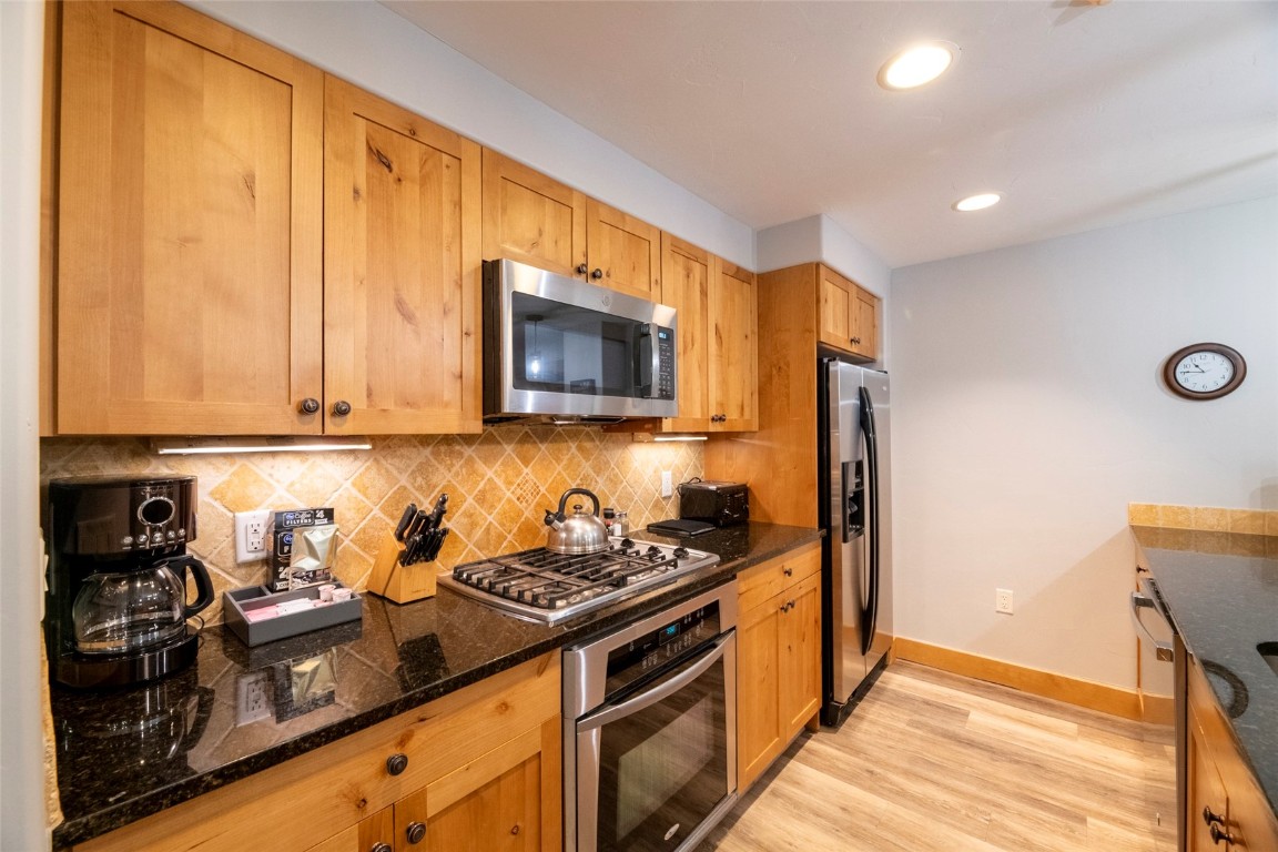 1875 Medicine Springs Road, Unit 4205 Steamboat Springs, CO 80487 - Photo 11 of 43 a kitchen with sink cabinets and appliances