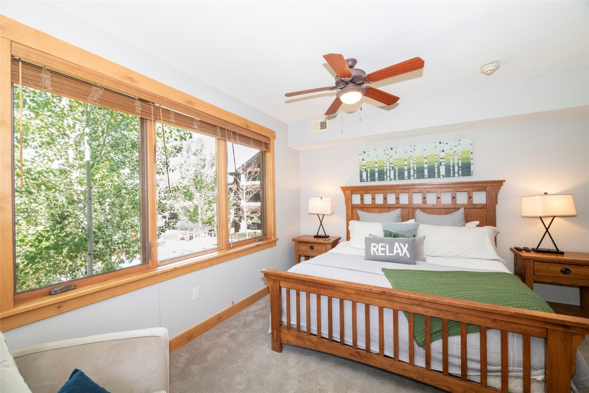 1875 Medicine Springs Road, Unit 4205 Steamboat Springs, CO 80487 - Photo 12 of 43 a bedroom with furniture and a large window