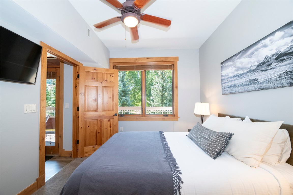 1875 Medicine Springs Road, Unit 4205 Steamboat Springs, CO 80487 - Photo 18 of 43 a bedroom with a large bed and a flat tv screen on dresser