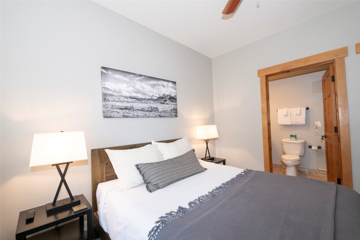 1875 Medicine Springs Road, Unit 4205 Steamboat Springs, CO 80487 - Photo 19 of 43 a bedroom with a bed and a lamp on dresser