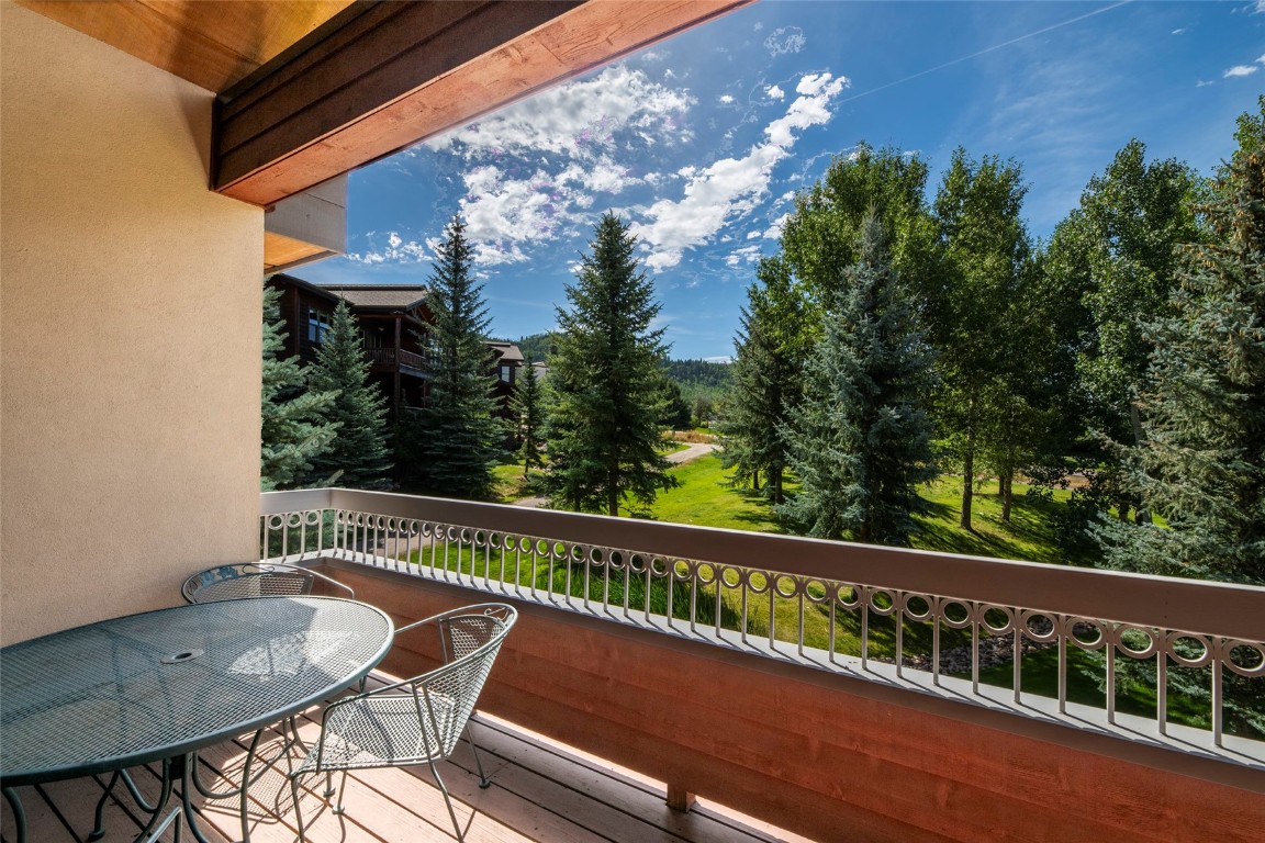 1875 Medicine Springs Road, Unit 4205 Steamboat Springs, CO 80487 - Photo 22 of 43 a view of a chair and table on the wooden floor