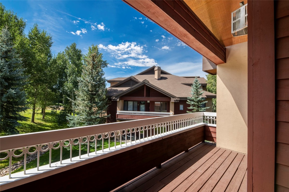 1875 Medicine Springs Road, Unit 4205 Steamboat Springs, CO 80487 - Photo 23 of 43 a view of a balcony with wooden floor and fence