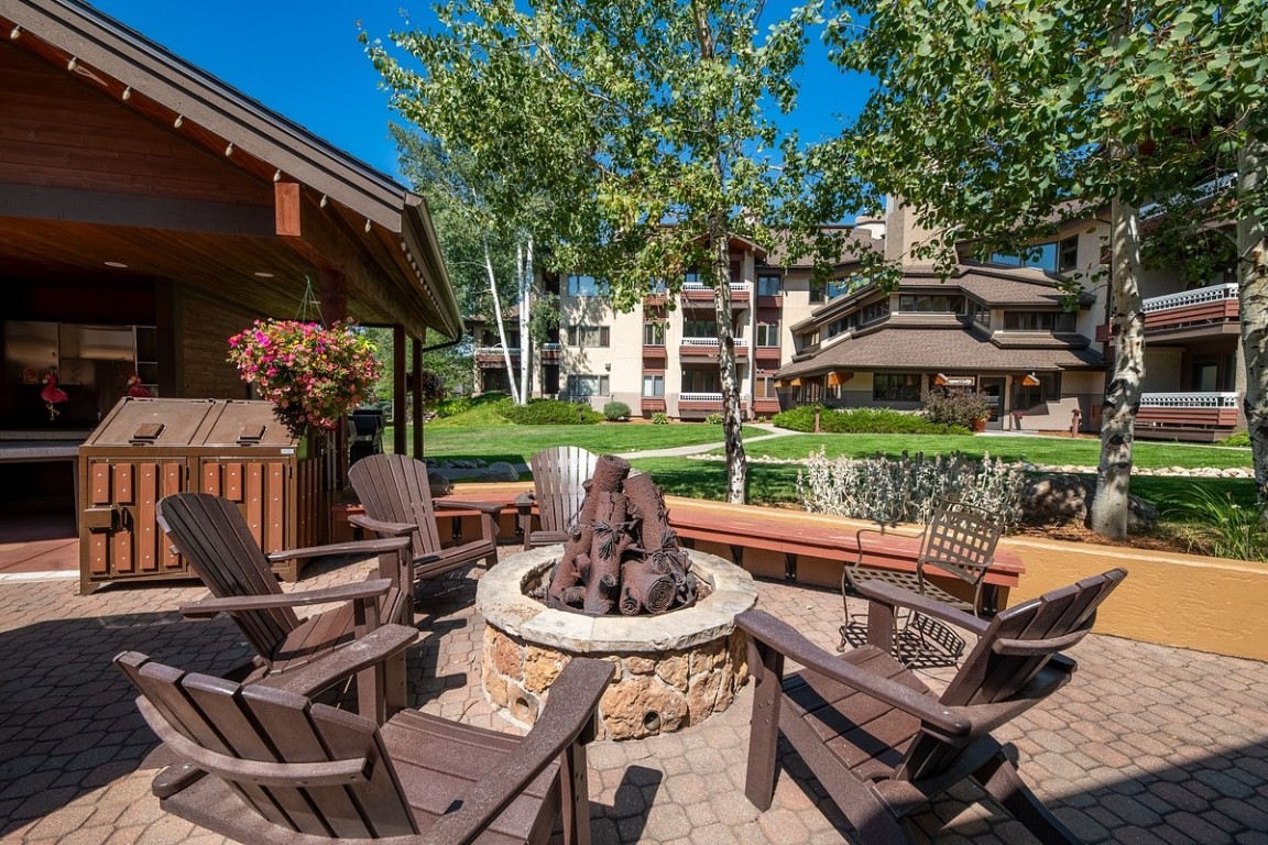 1875 Medicine Springs Road, Unit 4205 Steamboat Springs, CO 80487 - Photo 33 of 43 a view of a patio with couches table and chairs and a barbeque