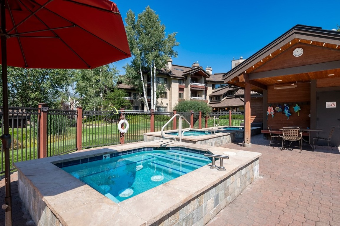 1875 Medicine Springs Road, Unit 4205 Steamboat Springs, CO 80487 - Photo 37 of 43 a view of a backyard with a table and chairs under an umbrella