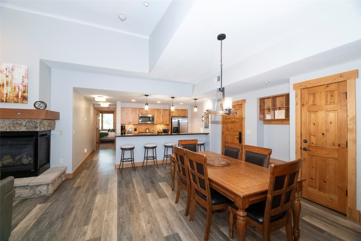 1875 Medicine Springs Road, Unit 4205 Steamboat Springs, CO 80487 - Photo 4 of 43 a dining room with furniture a chandelier and wooden floor
