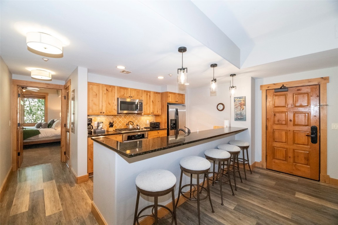 1875 Medicine Springs Road, Unit 4205 Steamboat Springs, CO 80487 - Photo 5 of 43 a large kitchen with a table and chairs