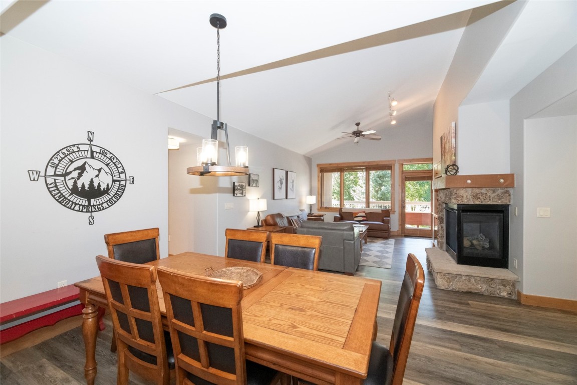 1875 Medicine Springs Road, Unit 4205 Steamboat Springs, CO 80487 - Photo 7 of 43 a dining room with furniture a chandelier and wooden floor