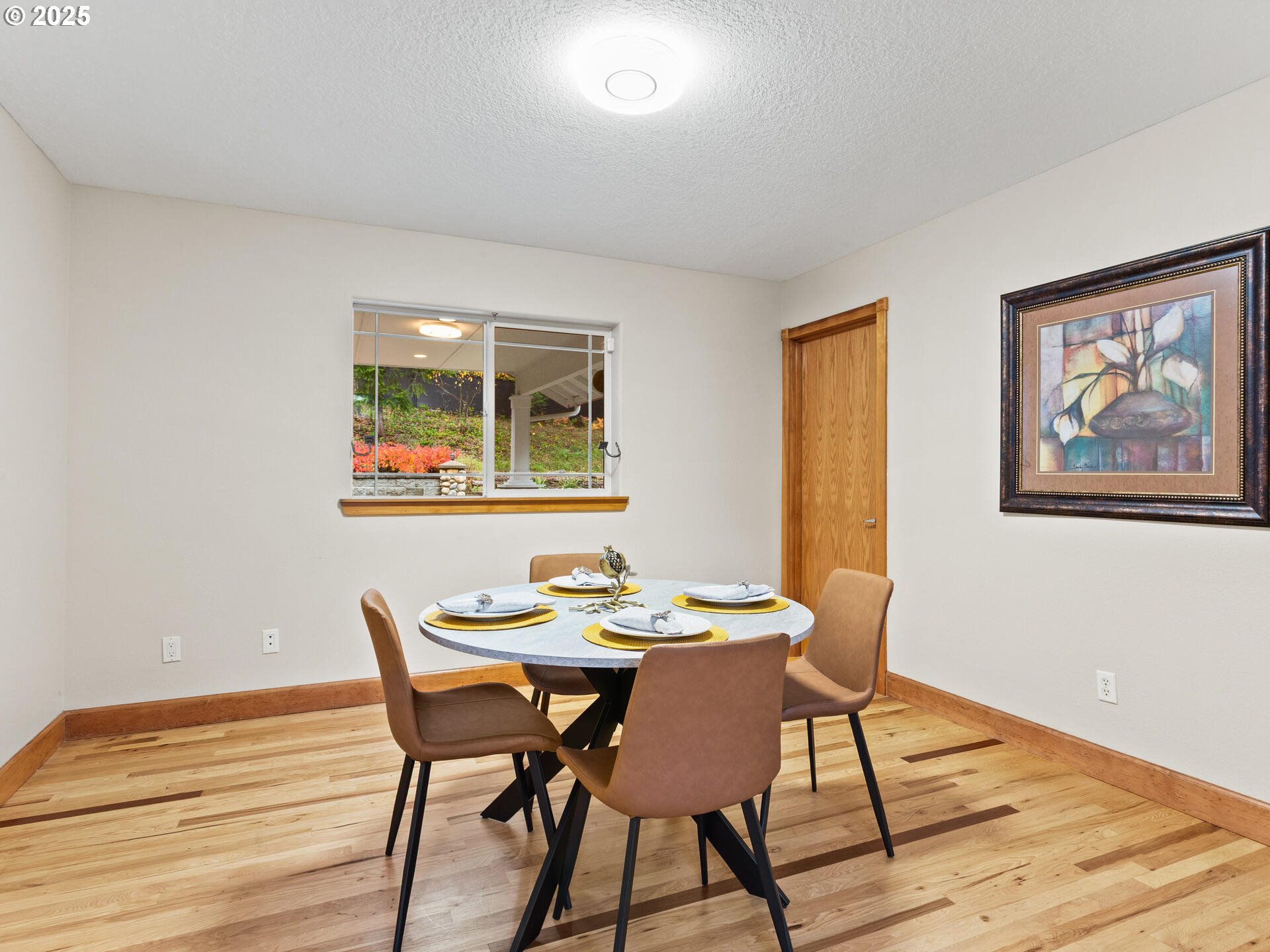 23403 Northeast Canyon Road Battle Ground, WA 98604 - Photo 12 of 48 a view of a dining room with furniture and wooden floor