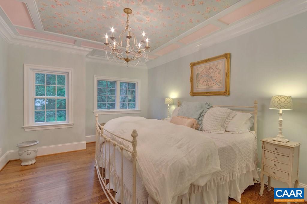 202 Sturbridge Road Charlottesville, VA 22901 - Photo 24 of 49 a spacious bedroom with a bed next to a window with a chandelier