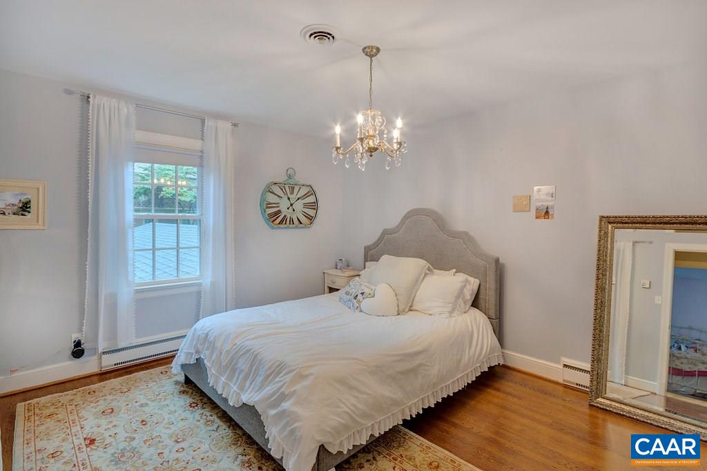 202 Sturbridge Road Charlottesville, VA 22901 - Photo 36 of 49 a bedroom with a bed and a chandelier