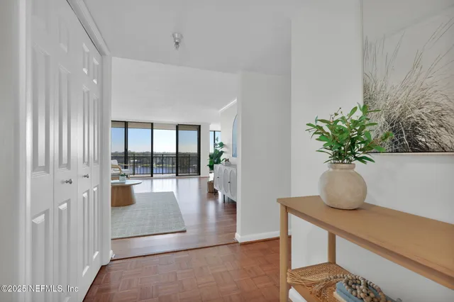 a living room with furniture and a large window with outer view