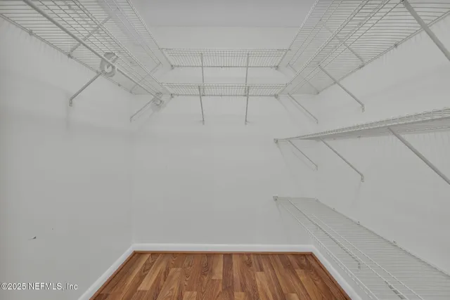 a view of a ocean with boats and trees in the background