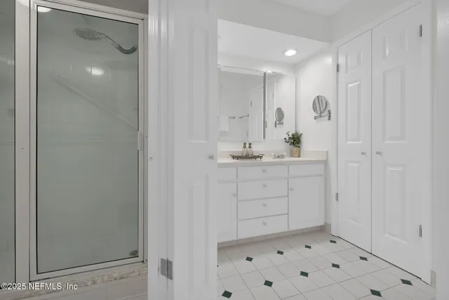 a view of a ocean with boats and trees in the background