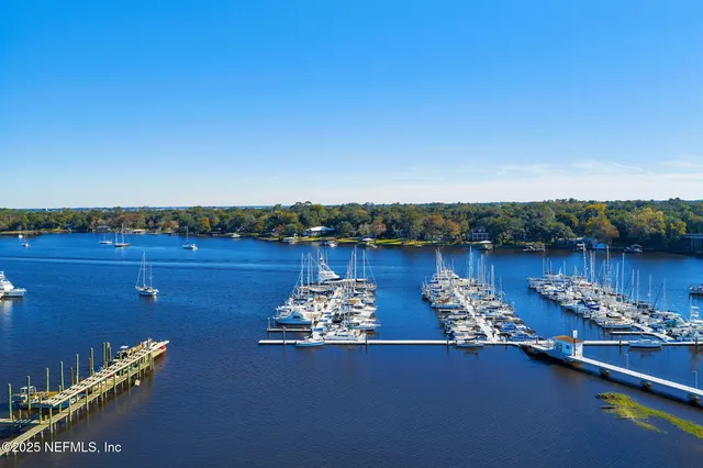 a very nice looking living room with a large window and a table