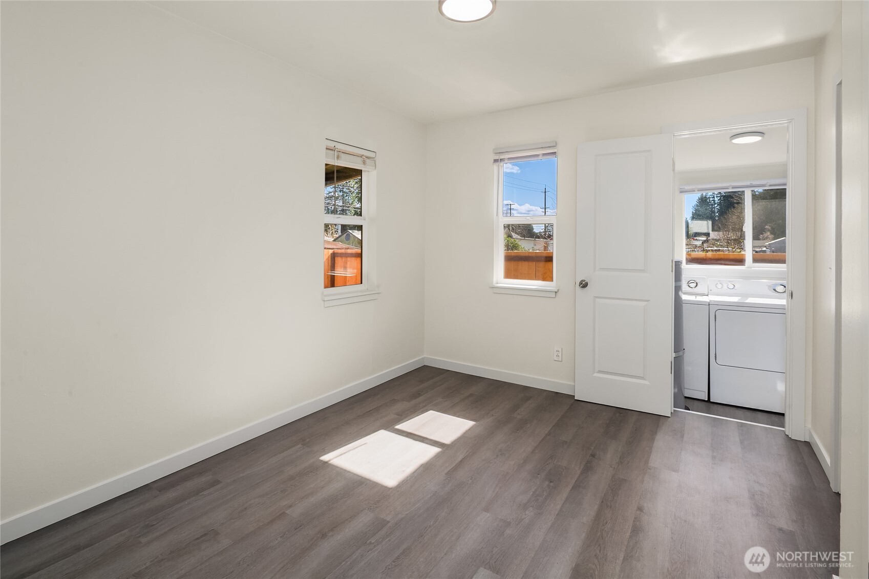 420 107th Place Southwest, Unit 1 Everett, WA 98204 - Photo 13 of 15 an empty room with wooden floor and windows