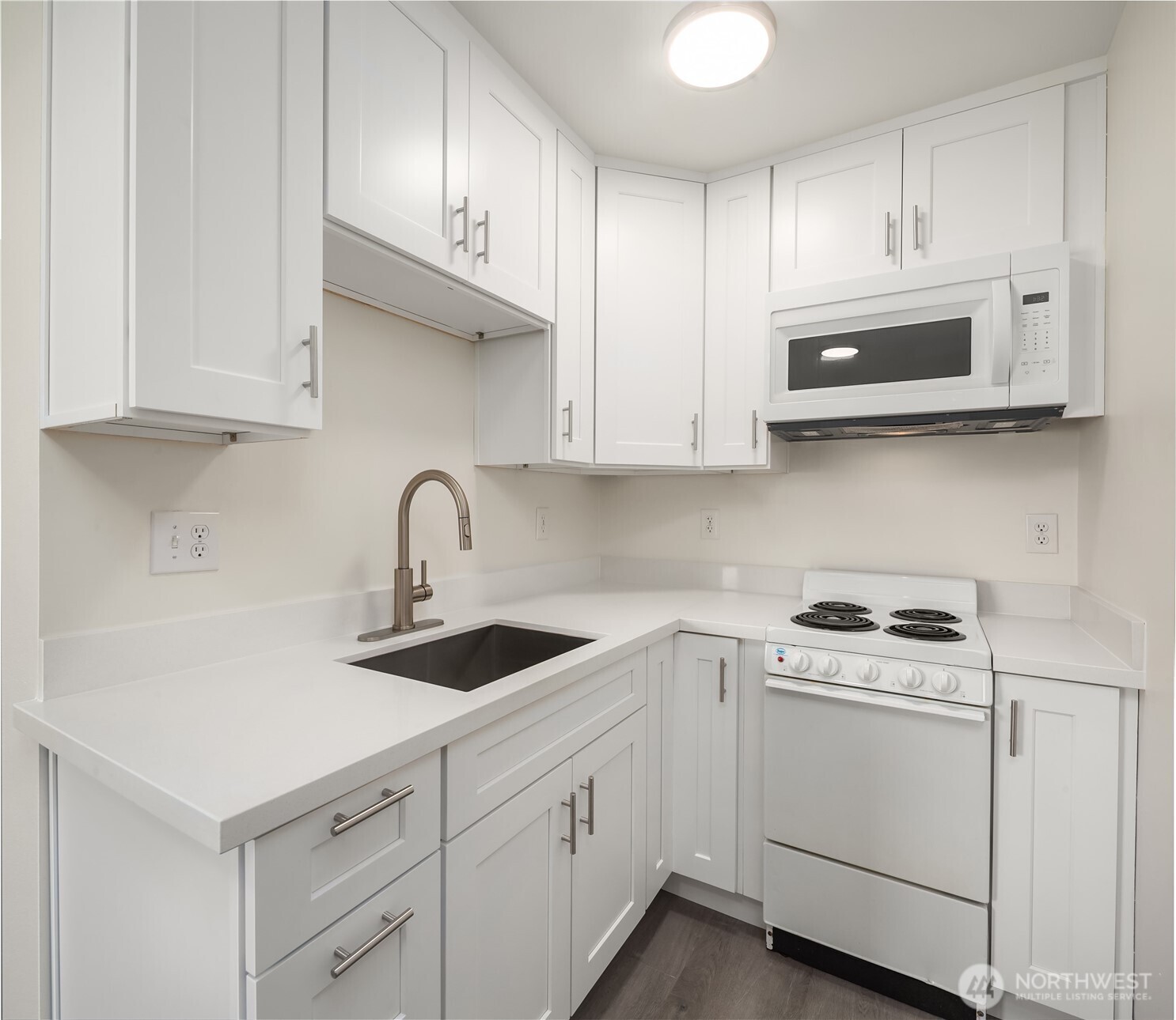 420 107th Place Southwest, Unit 1 Everett, WA 98204 - Photo 2 of 15 a kitchen with white cabinets and white appliances