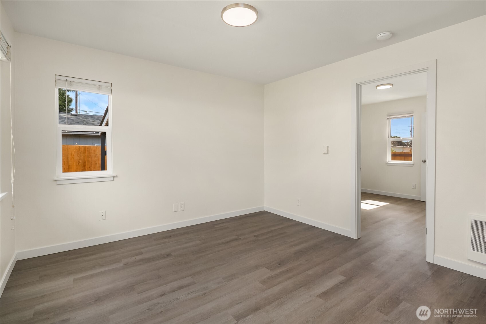 420 107th Place Southwest, Unit 1 Everett, WA 98204 - Photo 5 of 15 an empty room with wooden floor and windows