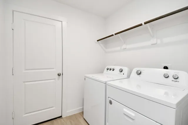 a bathroom with a glass shower door and sink