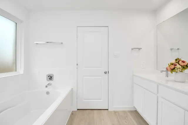 a bathroom with a sink mirror and vanity