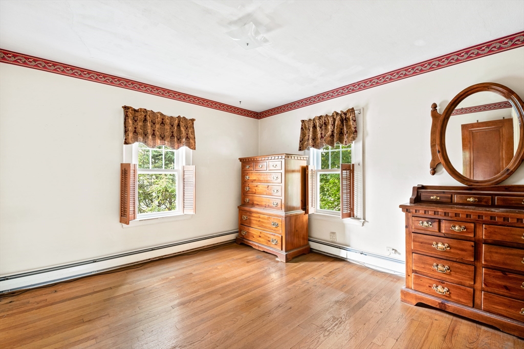 277 Appleton Street Arlington, MA 02476 - Photo 12 of 21 an empty room with windows cabinet and wooden floor