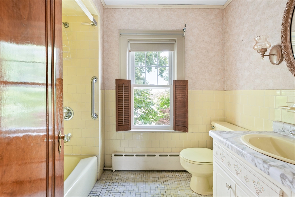 277 Appleton Street Arlington, MA 02476 - Photo 14 of 21 a bathroom with a granite countertop toilet a sink and a bathtub