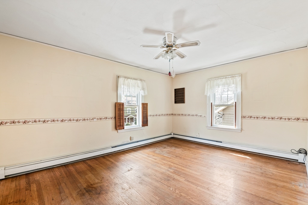 277 Appleton Street Arlington, MA 02476 - Photo 17 of 21 a view of an empty room with a window and wooden floor