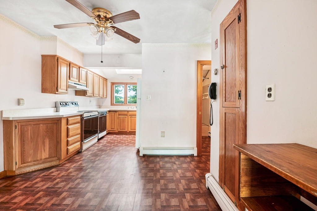 277 Appleton Street Arlington, MA 02476 - Photo 8 of 21 a view of a kitchen with a sink and a refrigerator