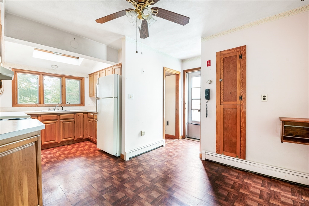 277 Appleton Street Arlington, MA 02476 - Photo 9 of 21 a view of a kitchen with a sink and a refrigerator