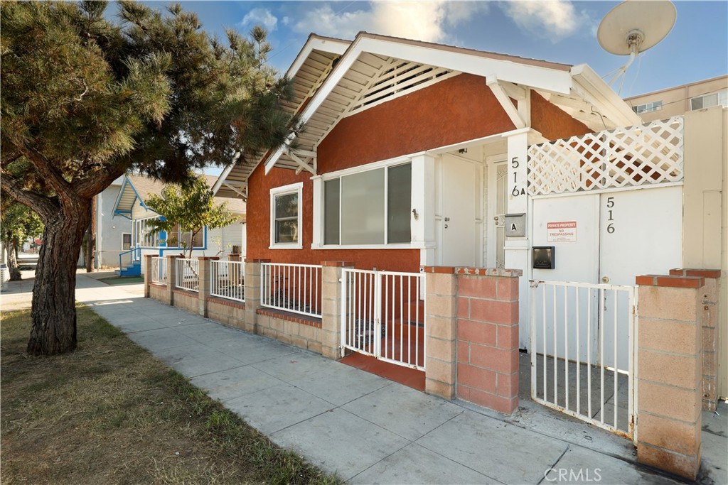 516 East 7th Street Long Beach, CA 90813 - Photo 1 of 1 a view of a house with a small yard and wooden fence
