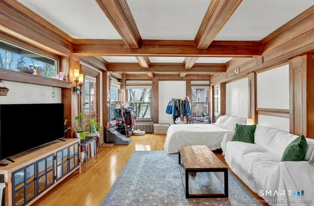 a living room with furniture a flat screen tv and a fireplace