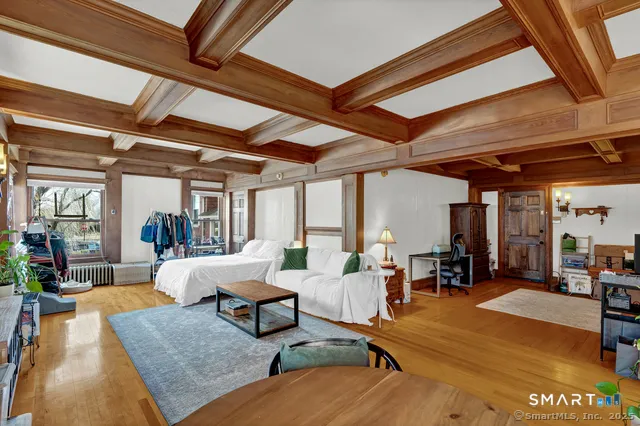 a bedroom with furniture and a large window