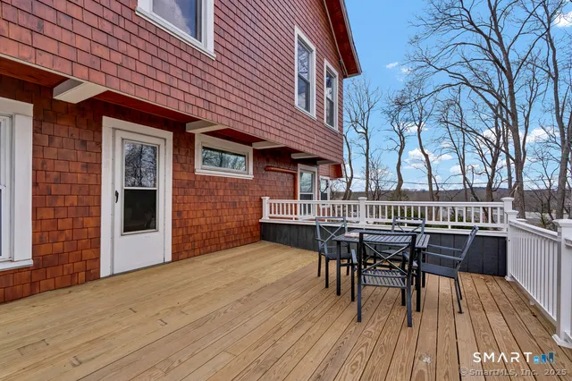 a view of balcony with deck wooden floor and outdoor seating