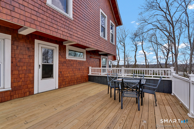 11 Winthrop Road, Unit B West Hartford, CT 06110 - Photo 16 of 27 a view of a roof deck with table and chairs and wooden floor