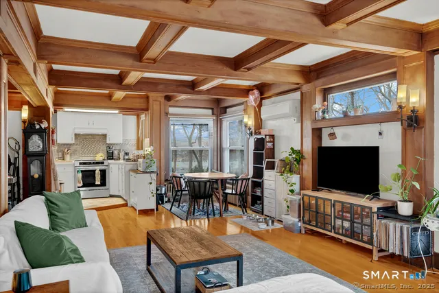 a living room with fireplace furniture and a flat screen tv