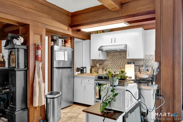 a kitchen with stainless steel appliances granite countertop a stove and a refrigerator