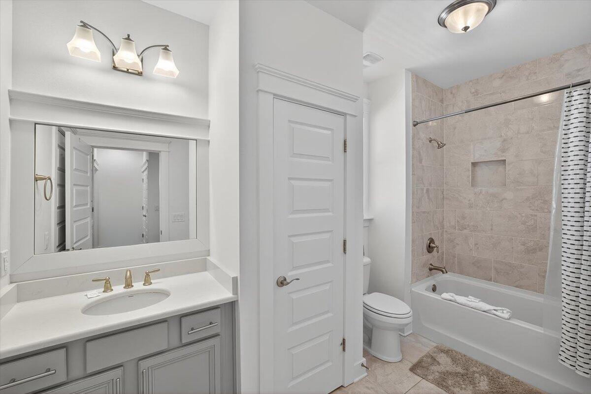 28 Emerald Beach Circle Santa Rosa Beach, FL 32459 - Photo 22 of 44 a bathroom with a granite countertop toilet a sink and a bathtub