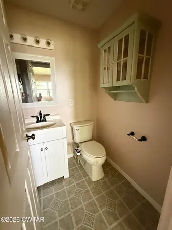 a bathroom with a sink a toilet and a mirror