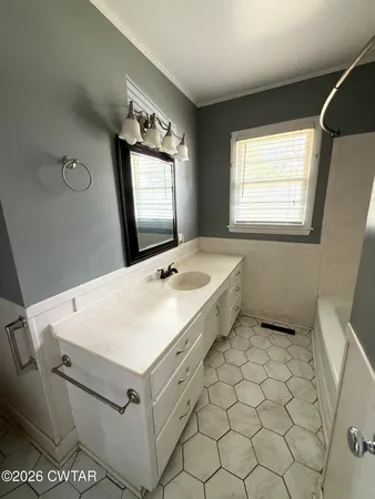a bathroom with a sink vanity and mirror