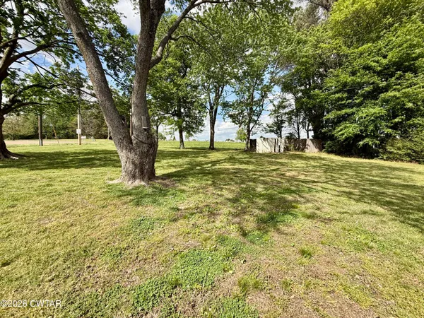 a view of outdoor space with trees all around