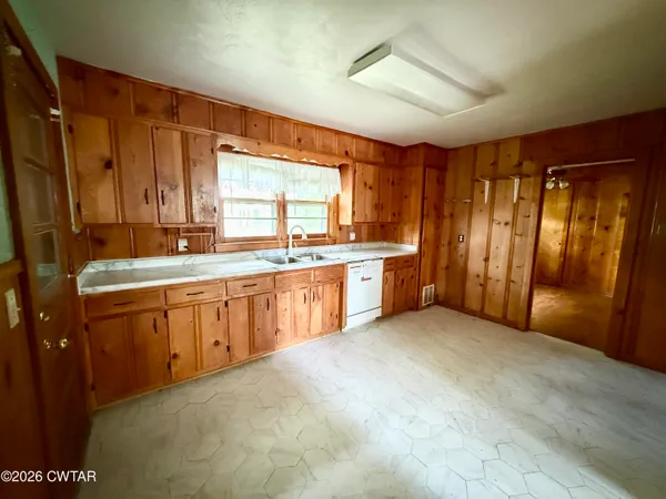 a large kitchen with a large window