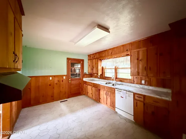 a large kitchen with a large counter top sink and cabinets