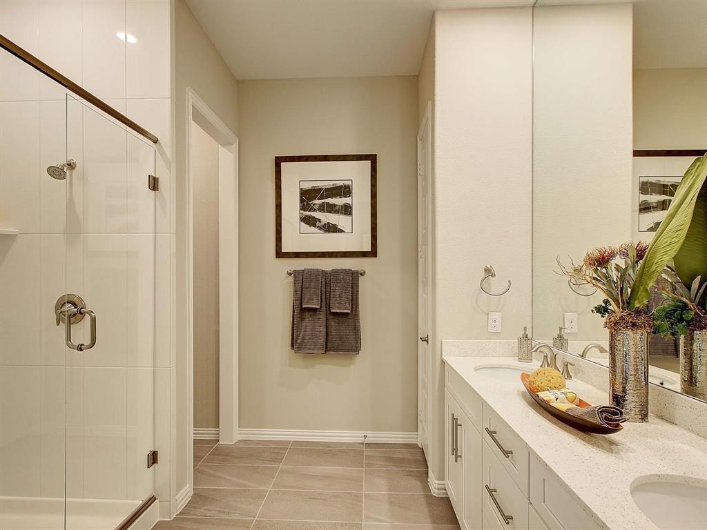 5634 Niagara Road The Colony, TX 75056 - Photo 16 of 31 a bathroom with a granite countertop sink a mirror and shower