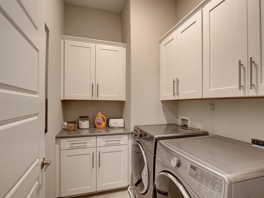 5634 Niagara Road The Colony, TX 75056 - Photo 18 of 31 a kitchen with white cabinets and white appliances
