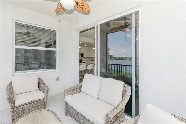 a view of a balcony with wooden floor and a potted plant