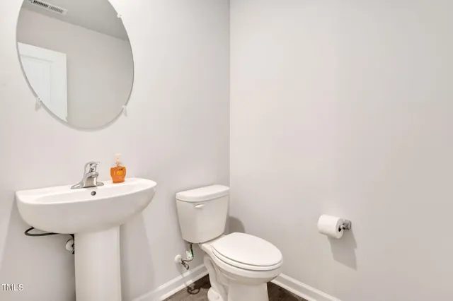 a kitchen with granite countertop white cabinets and a stove top oven