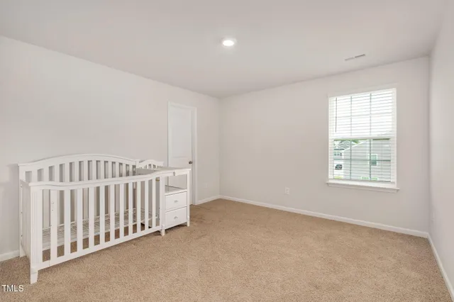 a spacious bathroom with double sink and a mirror
