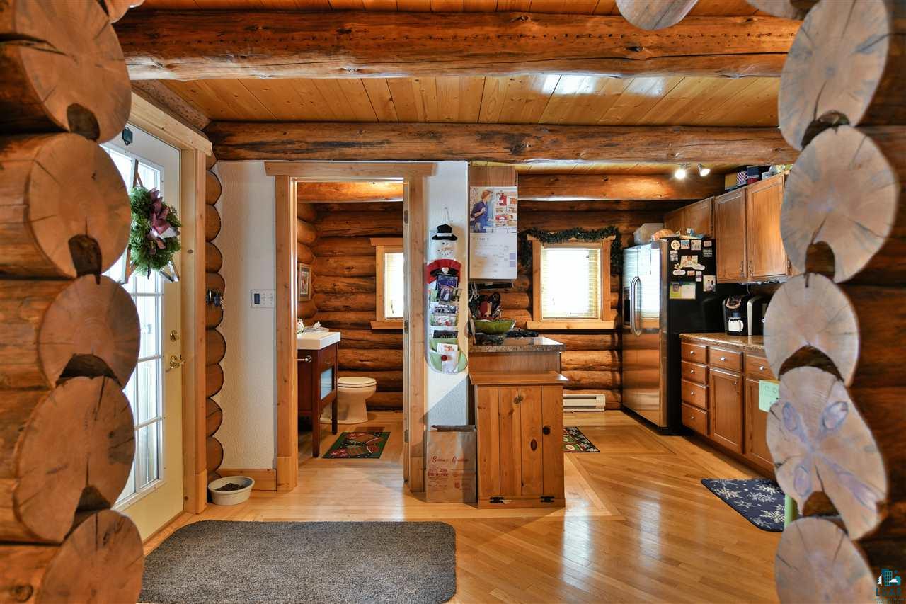 14251 Cosgrove Road Gordon, WI 54838 - Photo 8 of 35 From the Dining/Livingroom into the Kitchen/Entry. Look at the detail of the log ends. Beautiful!