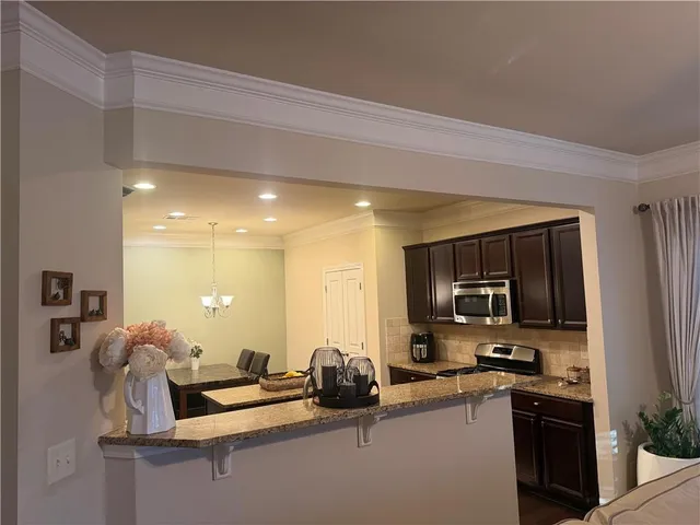 a kitchen with stainless steel appliances granite countertop a sink and cabinets