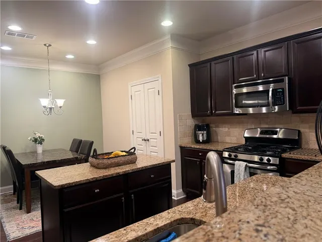 a kitchen with a sink stove and microwave